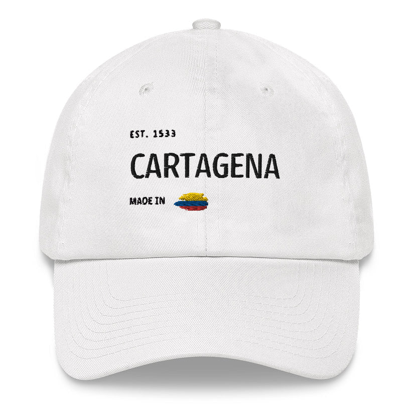 White dad hat featuring 'Cartagena - Made in Colombia' embroidered design with a small Colombian flag. A stylish tribute to Cartagena's rich history and culture.