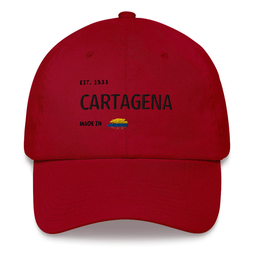 Cranberry red dad hat featuring 'Cartagena - Made in Colombia' embroidered design with a small Colombian flag. A stylish tribute to Cartagena's rich history and culture.
