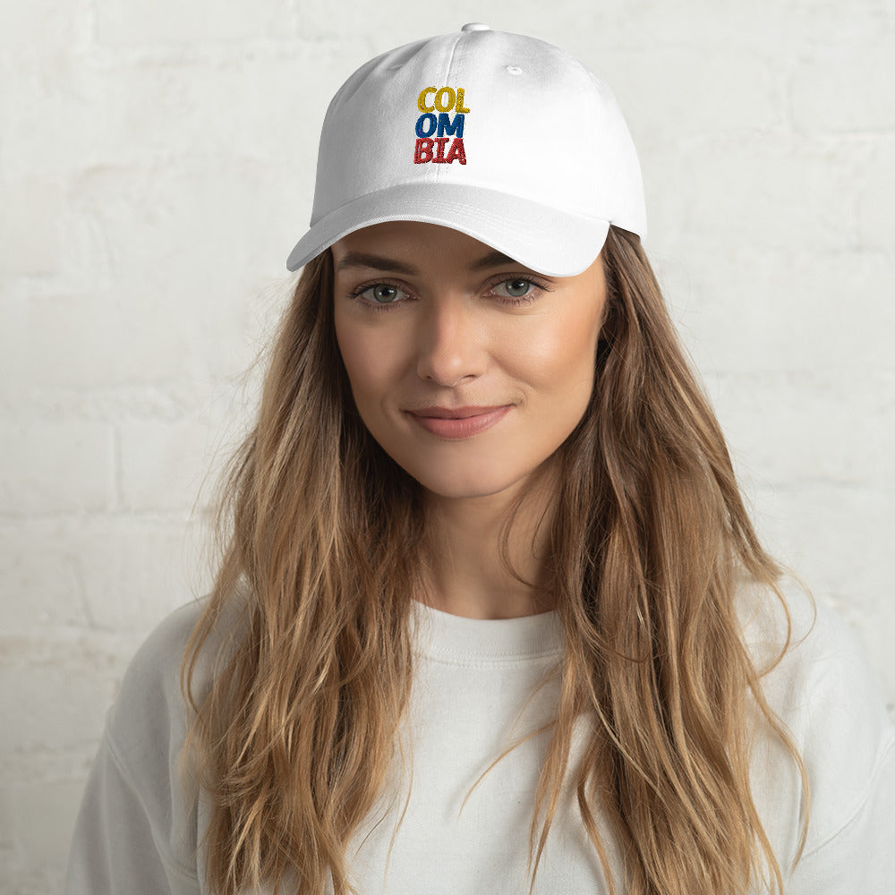 White dad hat featuring 'Colombia' embroidered in bold yellow, blue, and red lettering. A stylish and comfortable cap representing Colombian pride.