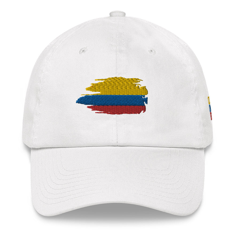 Classic white dad hat featuring an embroidered Colombian flag brushstroke design. A stylish and subtle way to represent Colombian pride with a modern artistic touch.