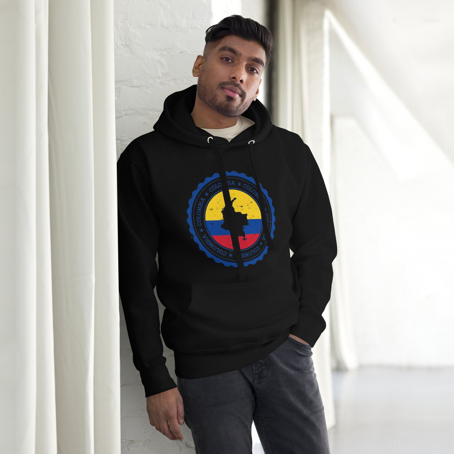 Unisex Black hoodie featuring a circular Colombian heritage design with vibrant yellow, blue, and red accents, perfect for showcasing cultural pride and style.