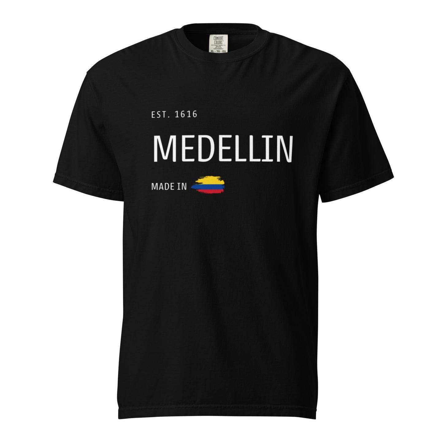 Black heavyweight t-shirt with 'Medellín - Made in Colombia' design. Features a minimalist city pride style with the Colombian flag. Perfect for those proud of their roots.