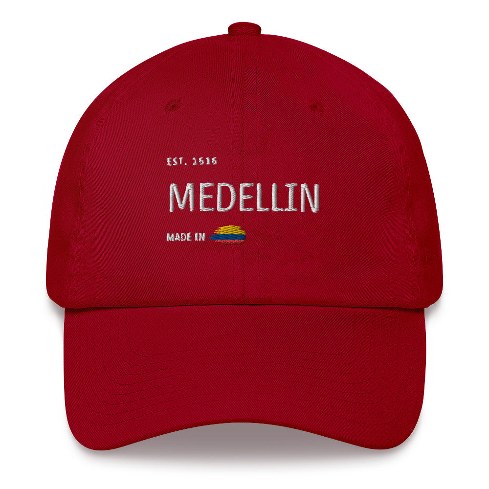 Classic Red cranberry dad hat featuring 'Medellín' embroidery with 'Made in Colombia' and Colombian flag detail. A stylish and versatile tribute to Medellín’s heritage.