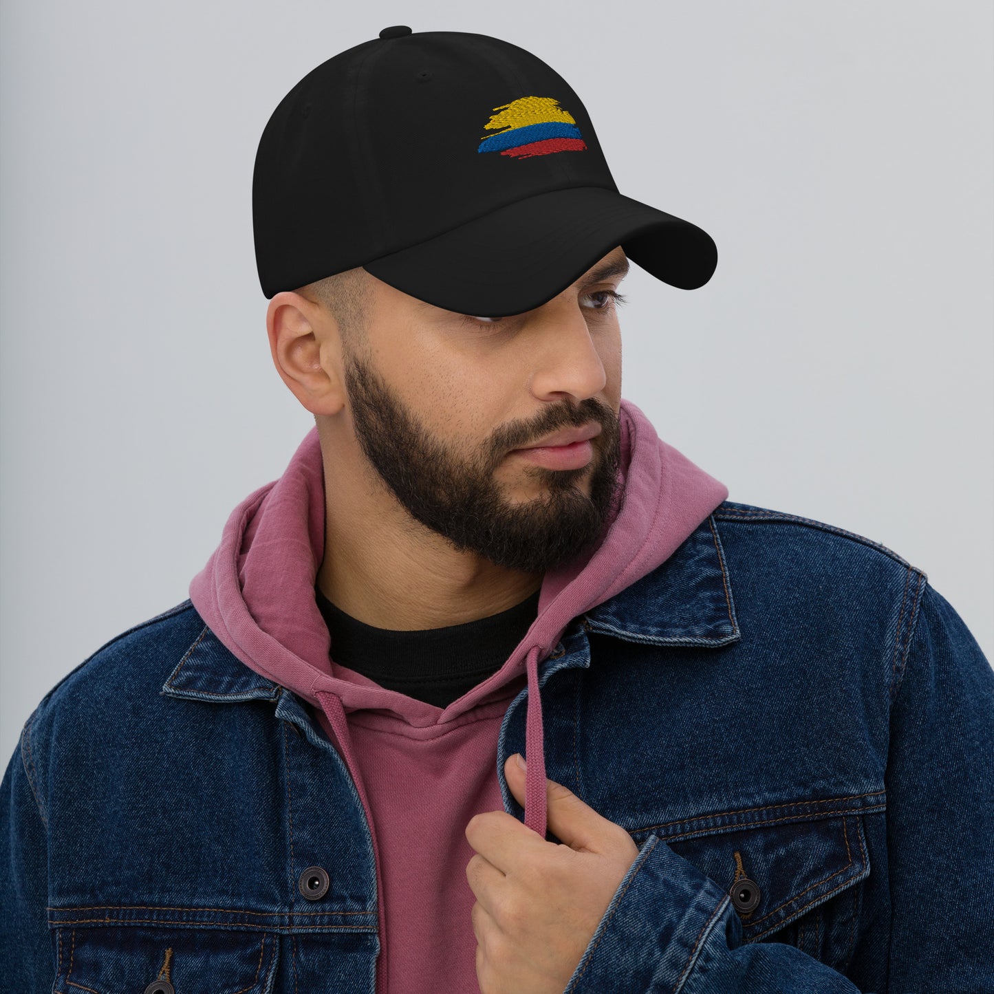 Classic Black dad hat featuring an embroidered Colombian flag brushstroke design. A stylish and subtle way to represent Colombian pride with a modern artistic touch.