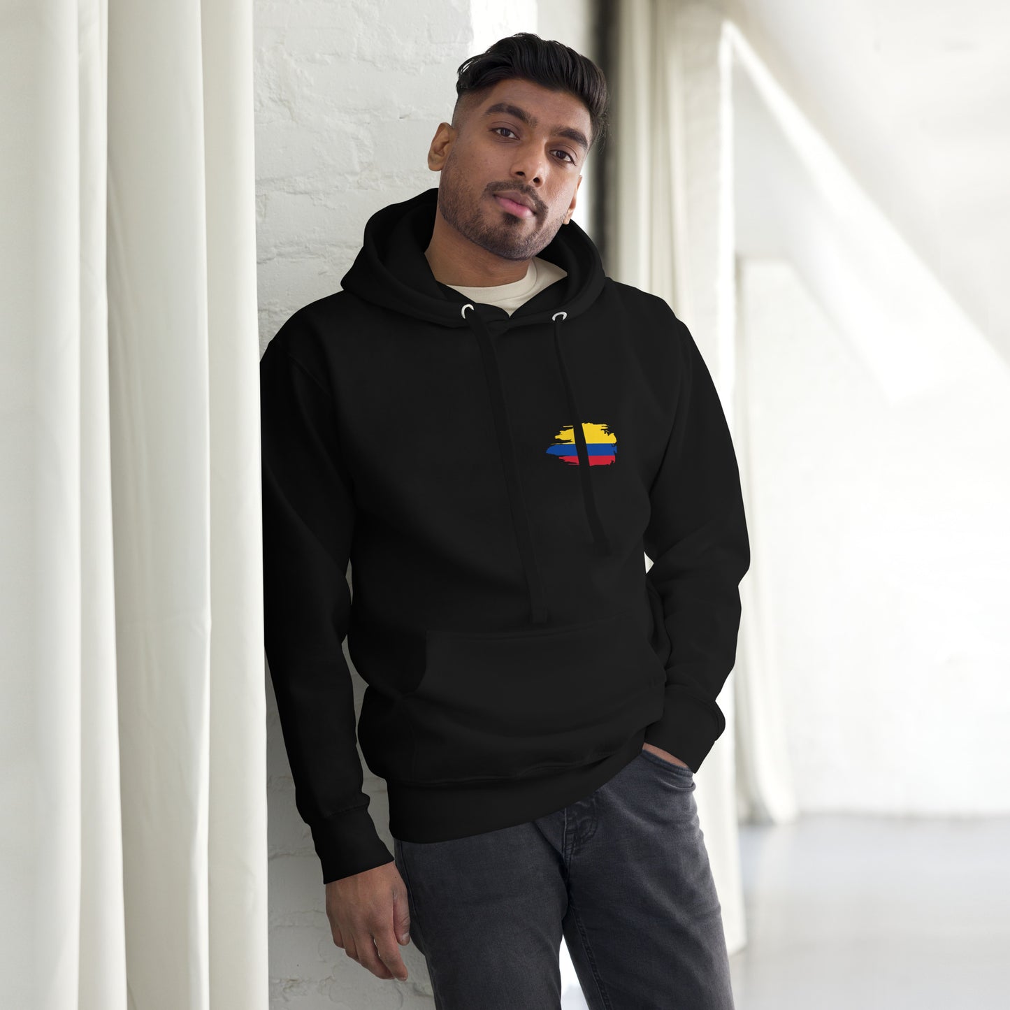Black hoodie featuring a playful 'Colombian Nutrition Facts' design with colorful text highlighting creativity, authenticity, passion, and pride, along with a heart-shaped Colombian flag graphic.