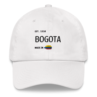 White dad hat featuring 'Bogota- Made in Colombia' embroidered design with a small Colombian flag. A stylish and minimal cap celebrating Bogota rich heritage and culture.