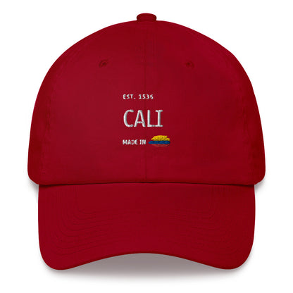 Classic Cranberry Red dad hat featuring 'Cali' embroidery with 'Made in Colombia' and Colombian flag detail. A stylish nod to Cali’s culture and heritage.