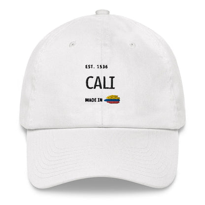 White dad hat featuring 'Cali - Made in Colombia' embroidered design with a small Colombian flag. A stylish and minimal cap celebrating Cali’s rich heritage and culture.