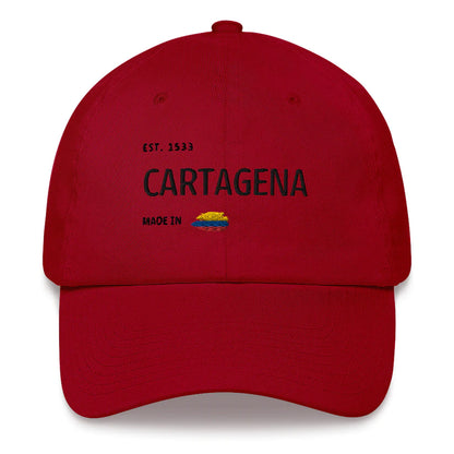 Cranberry red dad hat featuring 'Cartagena - Made in Colombia' embroidered design with a small Colombian flag. A stylish tribute to Cartagena's rich history and culture.