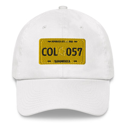 Classic white dad hat featuring a vintage yellow Colombian license plate design with 'COL 057 Suramérica' text. A stylish way to represent Colombian culture with a retro touch.