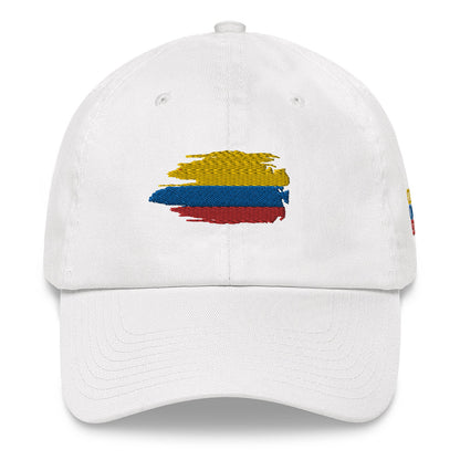 Classic white dad hat featuring an embroidered Colombian flag brushstroke design. A stylish and subtle way to represent Colombian pride with a modern artistic touch.