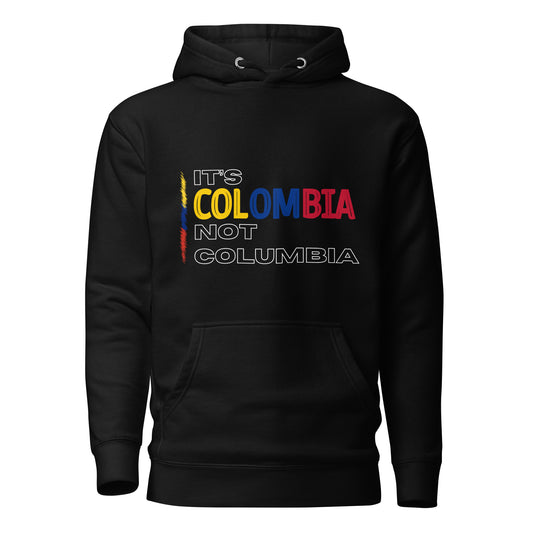 Unisex Black premium hoodie featuring the bold statement 'It's Colombia, Not Columbia,' emphasizing Colombian pride and identity. The design is a strong visual representation of cultural authenticity.