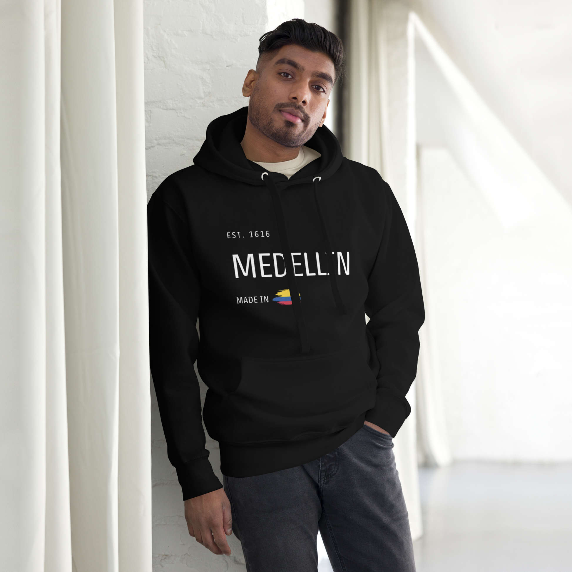 Black premium hoodie featuring 'Medellín' text, 'EST. 1616,' and a small Colombian flag design. A cozy and stylish tribute to Medellín, Colombia.