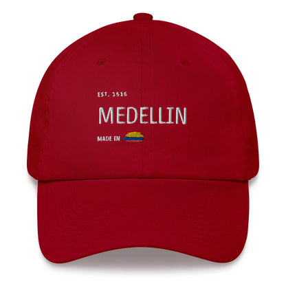 Classic Red cranberry dad hat featuring 'Medellín' embroidery with 'Made in Colombia' and Colombian flag detail. A stylish and versatile tribute to Medellín’s heritage.