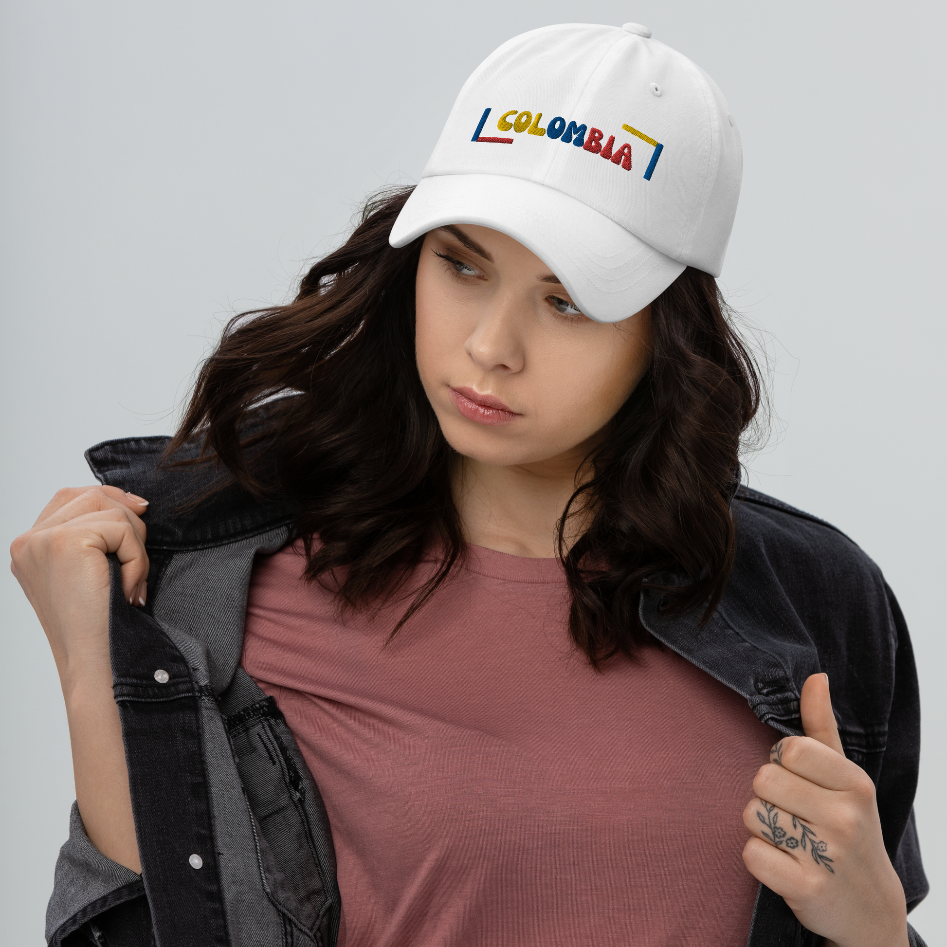 Classic white dad hat featuring a colorful 'COLOMBIA' text design in yellow, blue, and red, inspired by the Colombian flag.