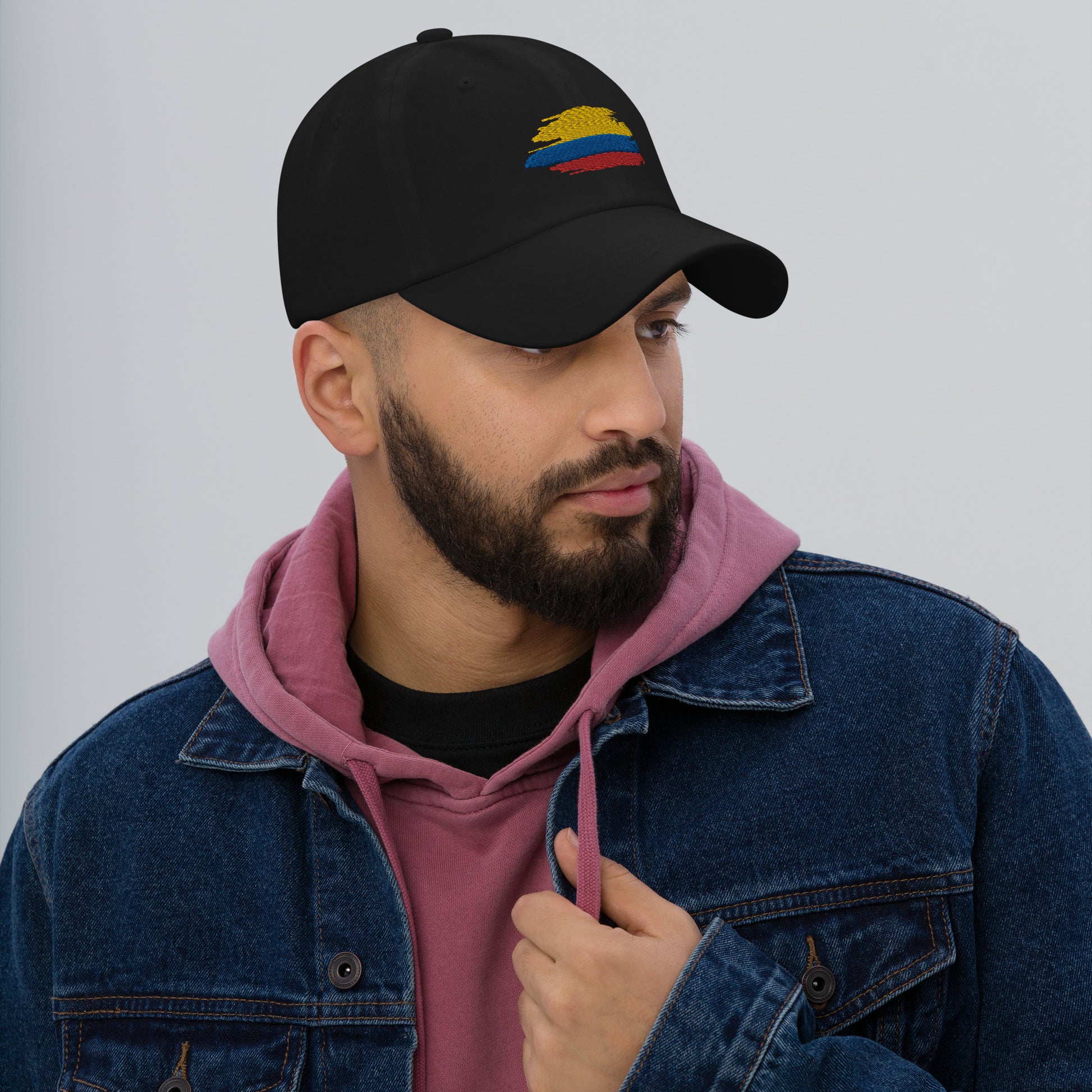 Classic Black dad hat featuring an embroidered Colombian flag brushstroke design. A stylish and subtle way to represent Colombian pride with a modern artistic touch.