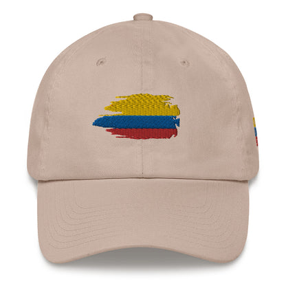Classic Stone dad hat featuring an embroidered Colombian flag brushstroke design. A stylish and subtle way to represent Colombian pride with a modern artistic touch.